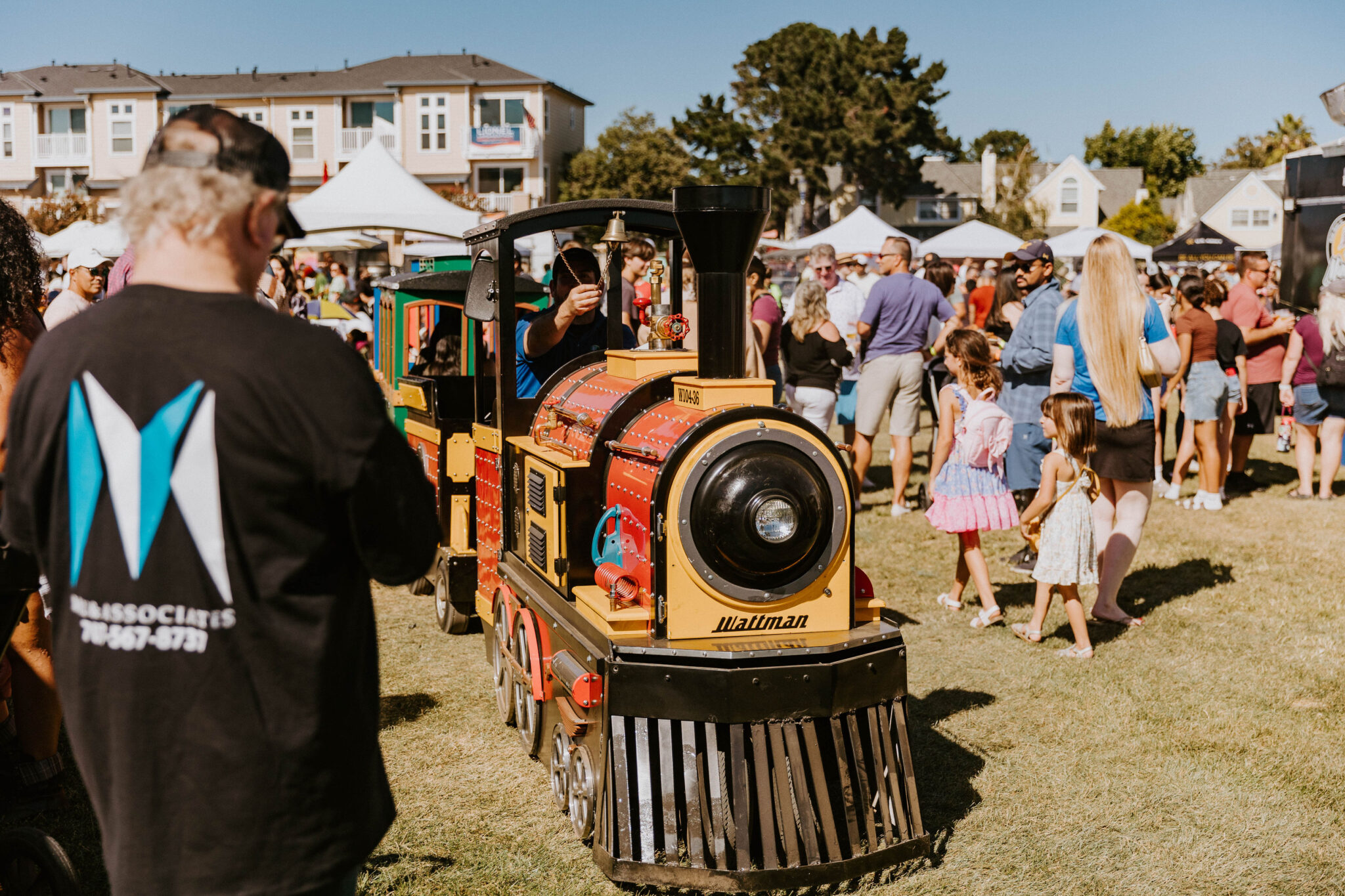 Miniature trackless train giving kids rides around the festival grounds